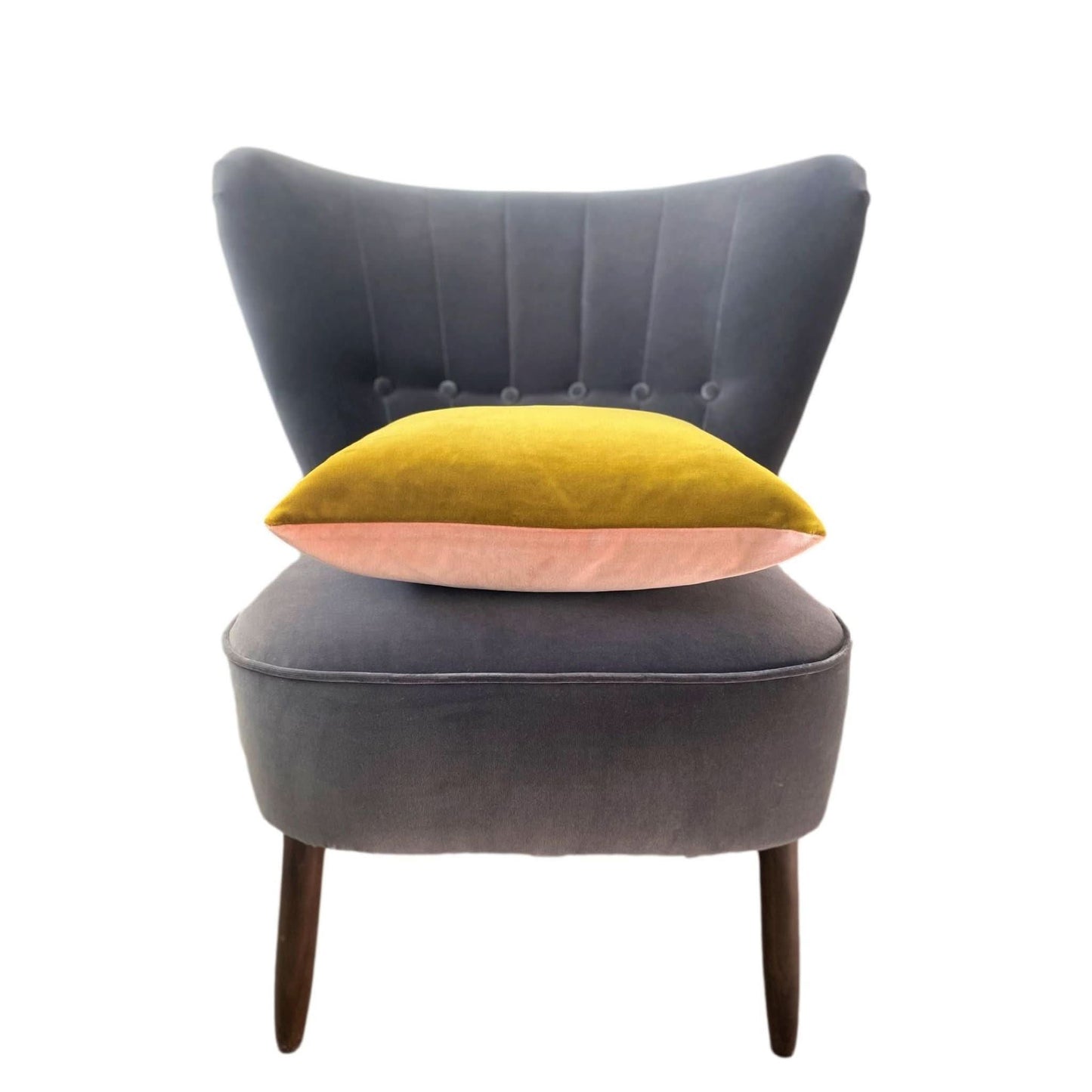 gold and blush pink velvet cushion on a grey velvet chair