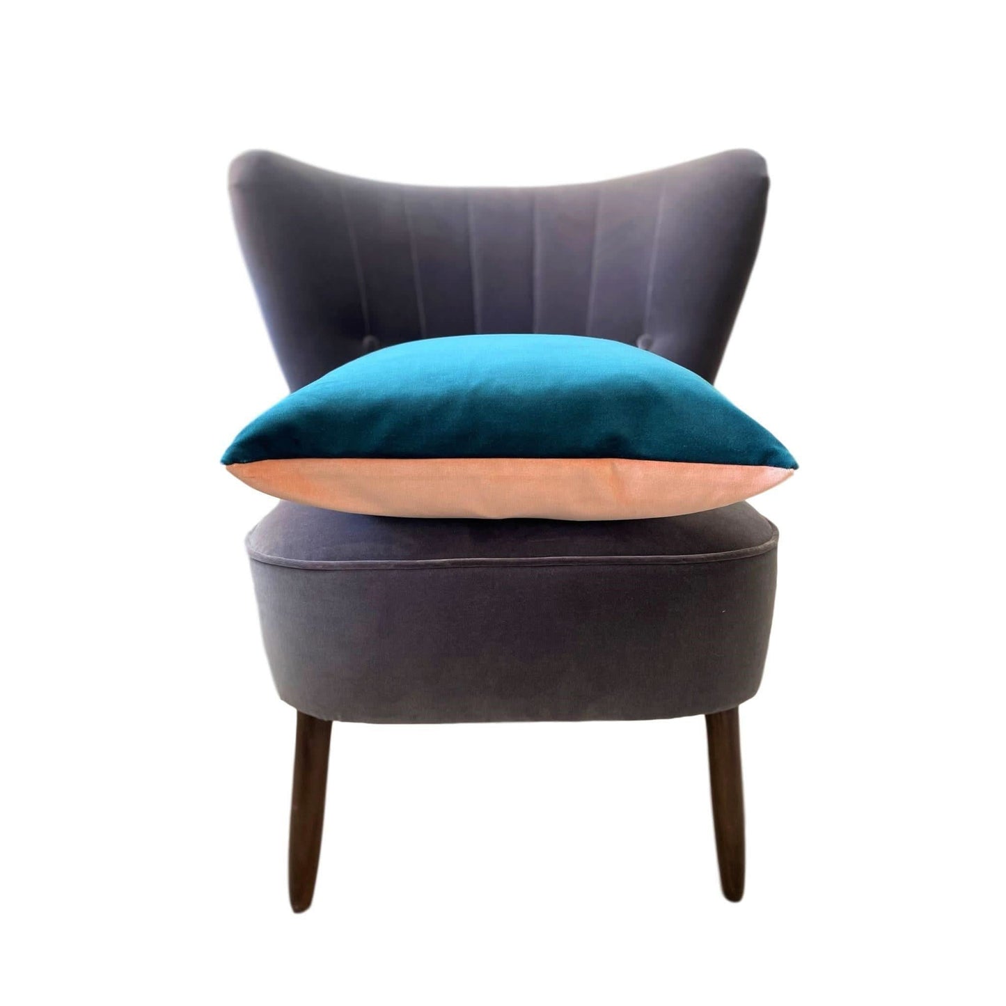 pink and teal velvet cushion on a dark grey velvet chair