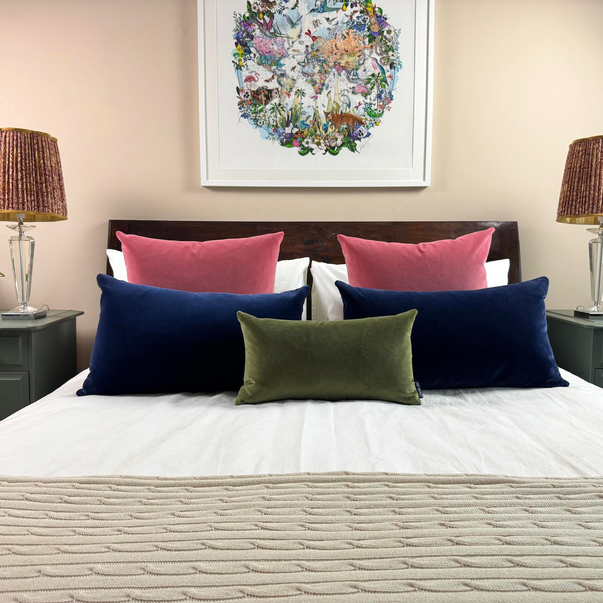 rose pink square velvet cushion covers with olive and navy on wooden bed