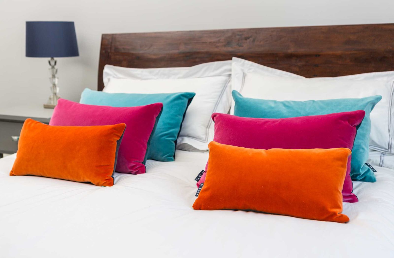 orange velvet cushions, pink velvet cushions and turquoise velvet cushions