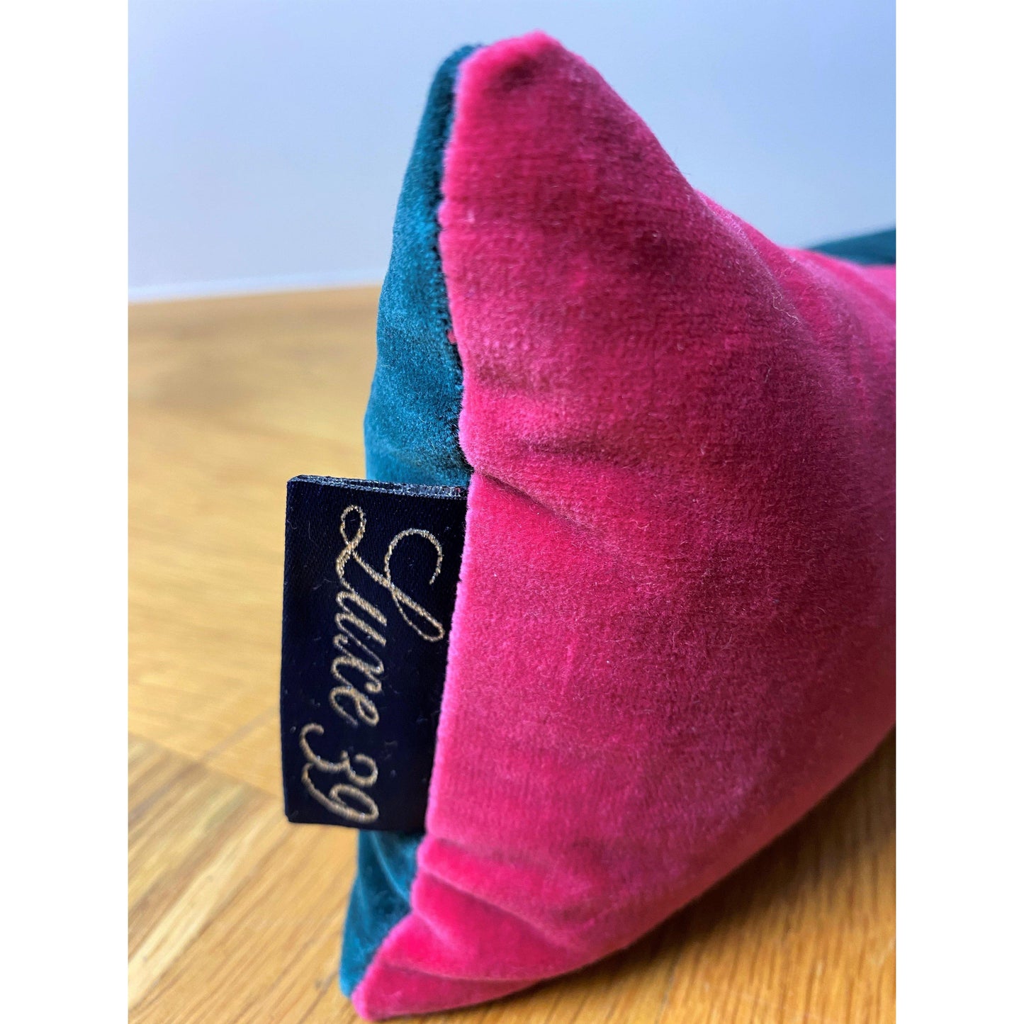 teal velvet draft excluder with bright pink