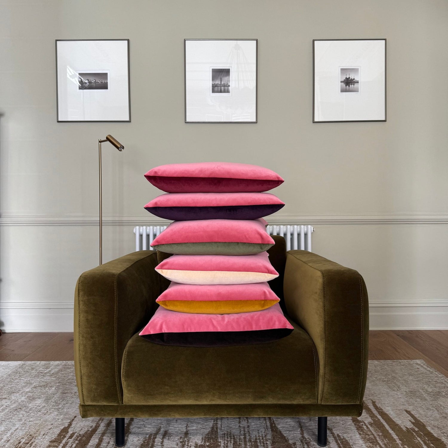 pink velvet cushions in two tones piled on green chair