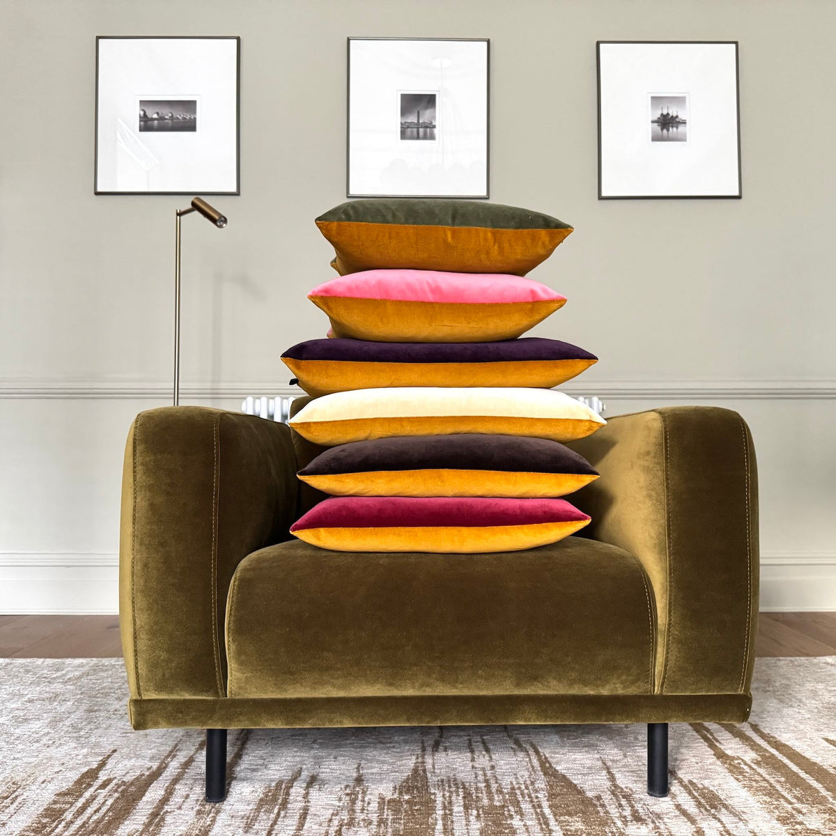 gold ochre velvet cushions piled on an olive chair