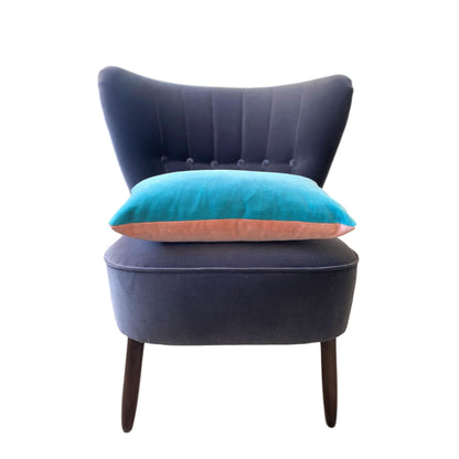 blush and turquoise velvet cushion cover on dark grey velvet sofa