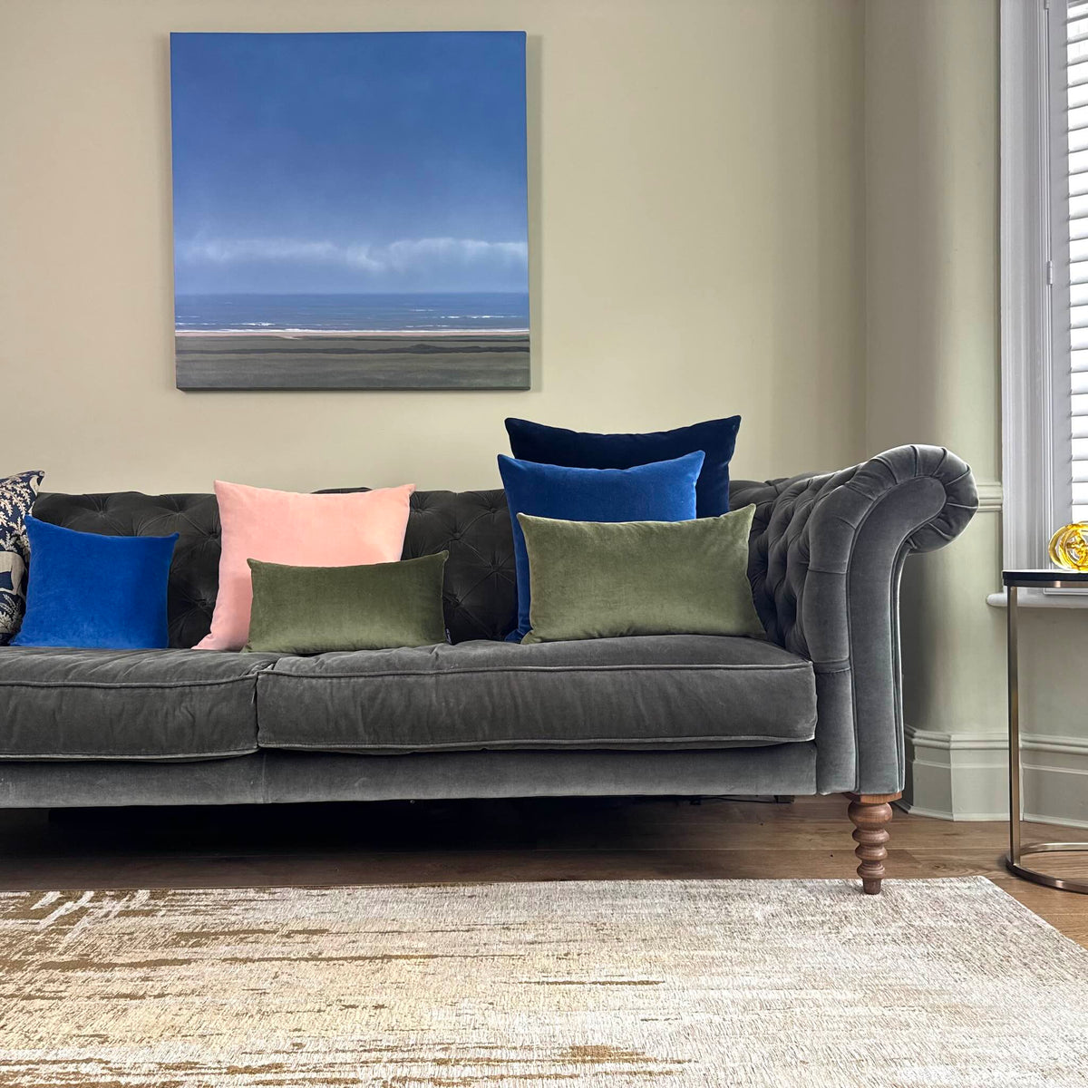 blush pink velvet cushion cover on grey sofa