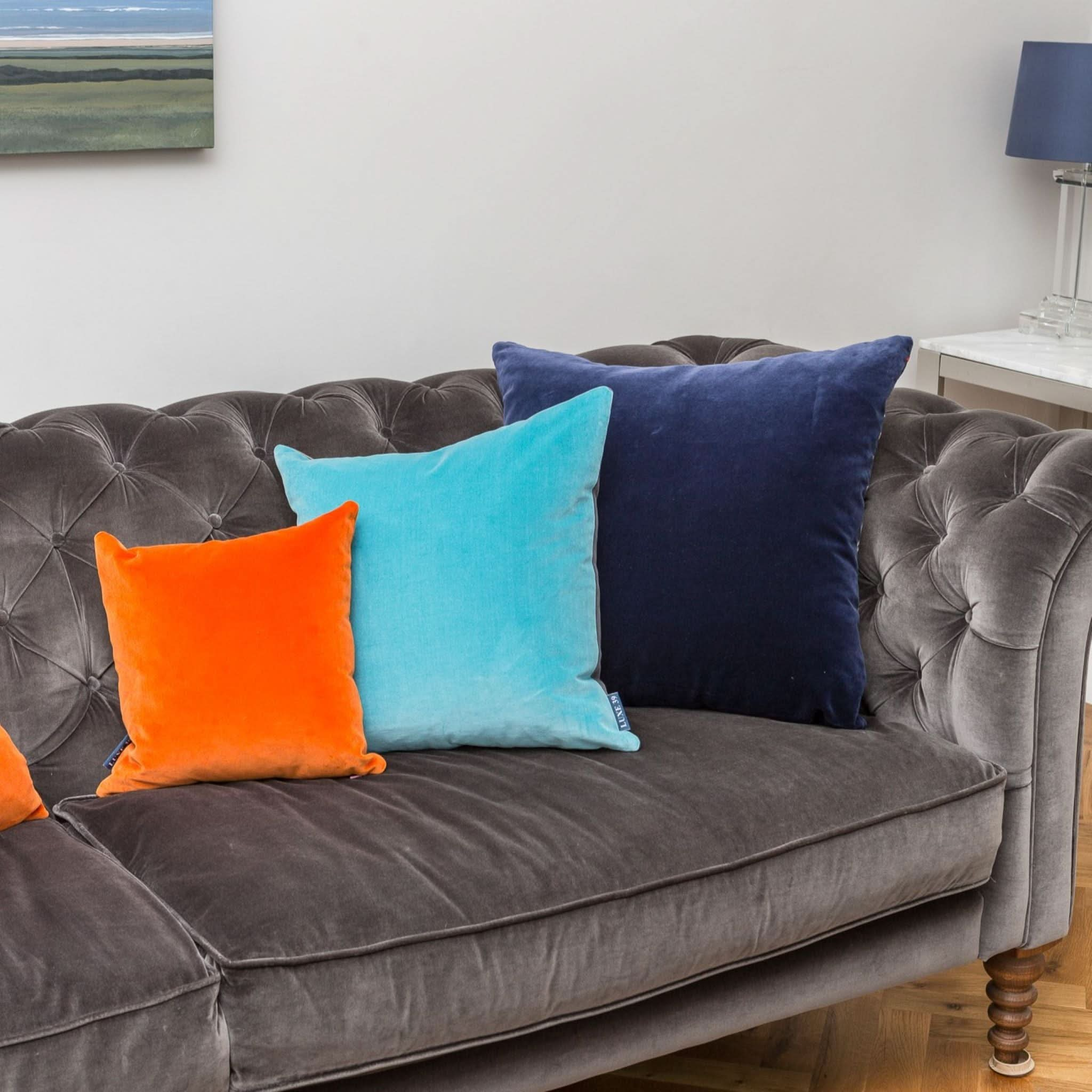 Grey sofa hotsell orange cushions