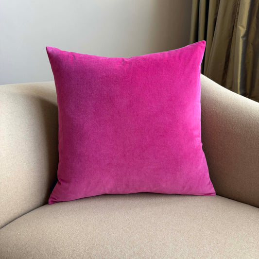 bright pink velvet cushion square on beige sofa