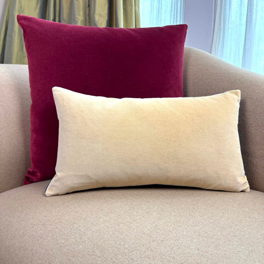 burgundy and champagne reversible velvet cushion cover on beige sofa