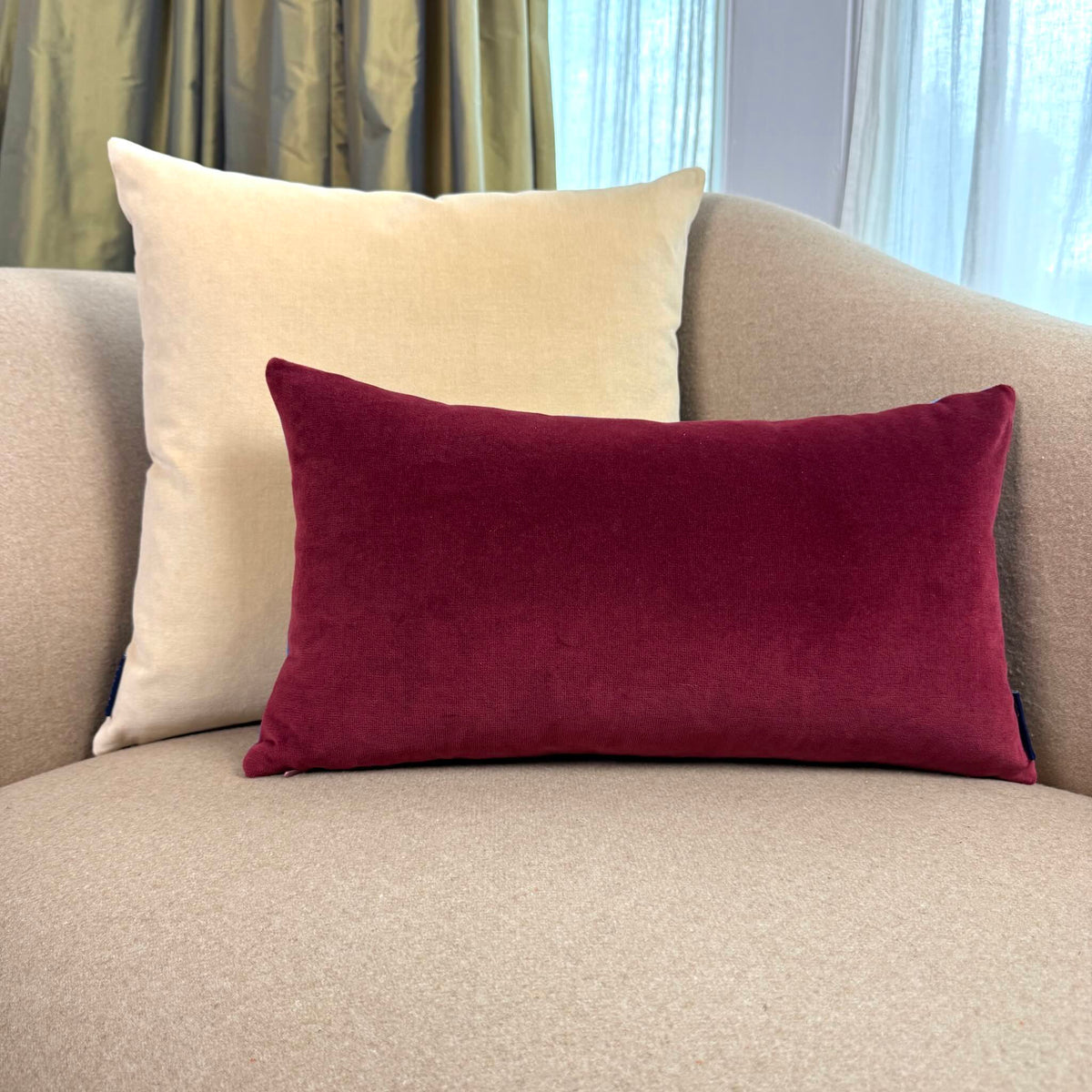 burgundy and champagne cream velvet cushion on beige sofa