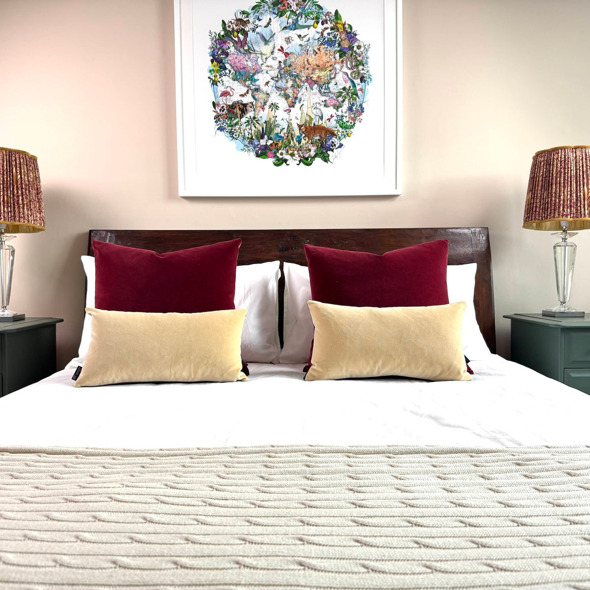 burgundy and champagne velvet cushions on wooden bed