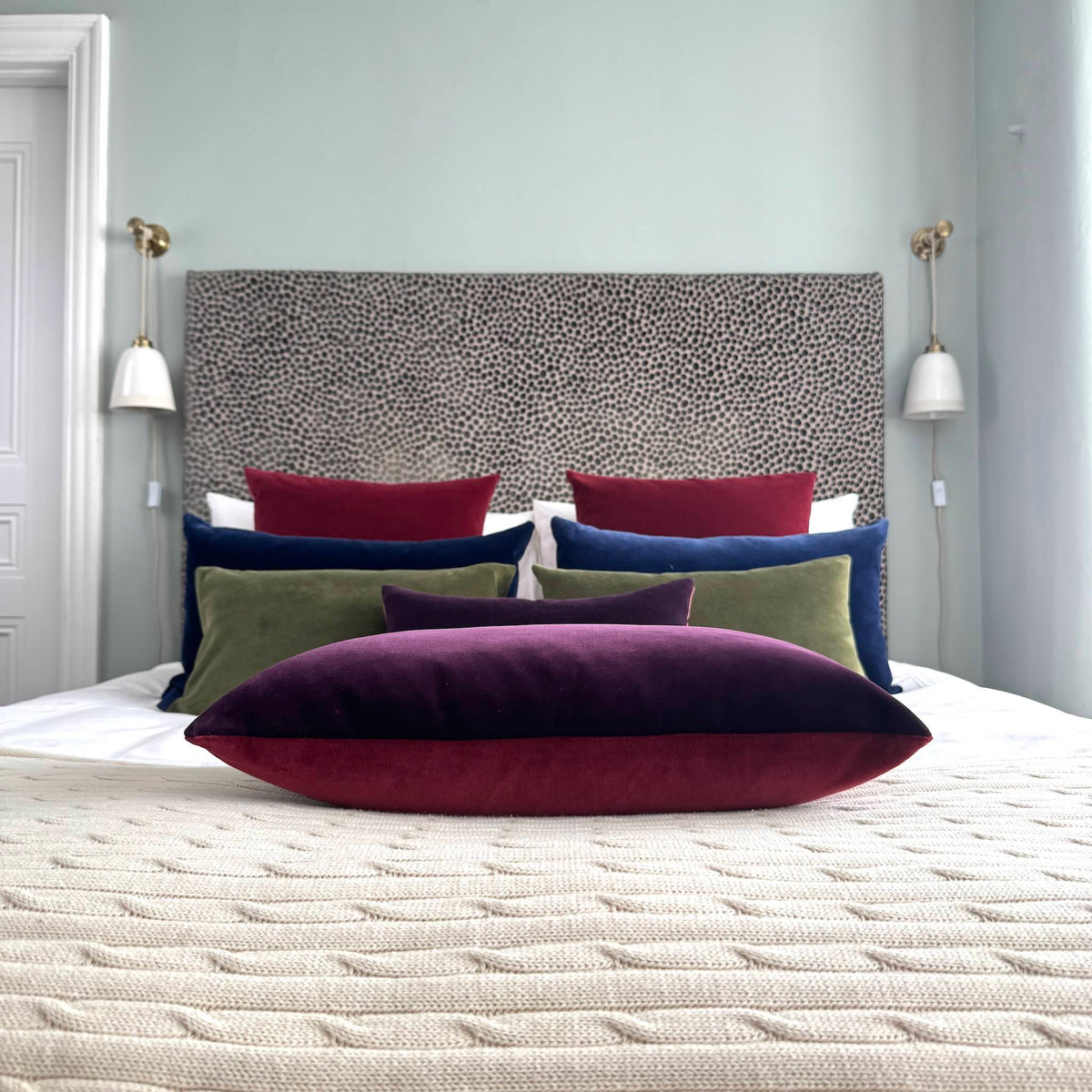 burgundy and plum reversible velvet cushion in blue room