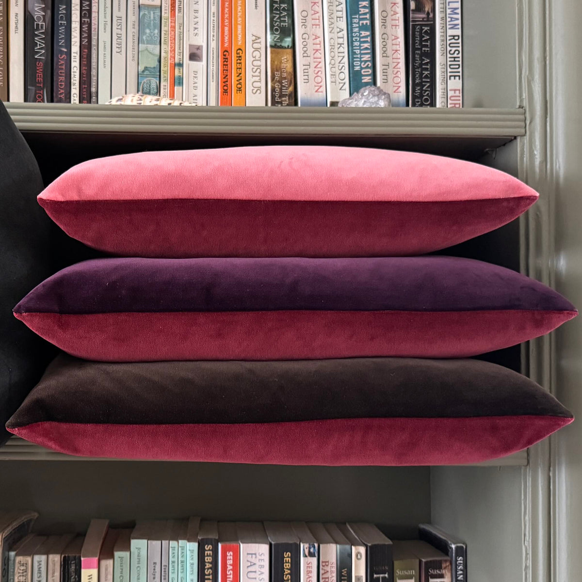 burgundy and plum reversible velvet cushion in bookshelf