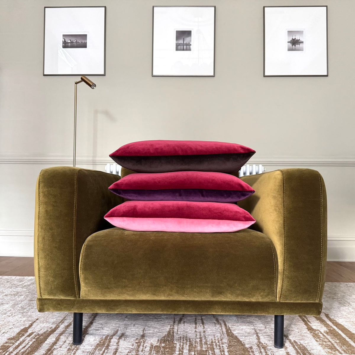burgundy and plum velvet cushion piled on green chair