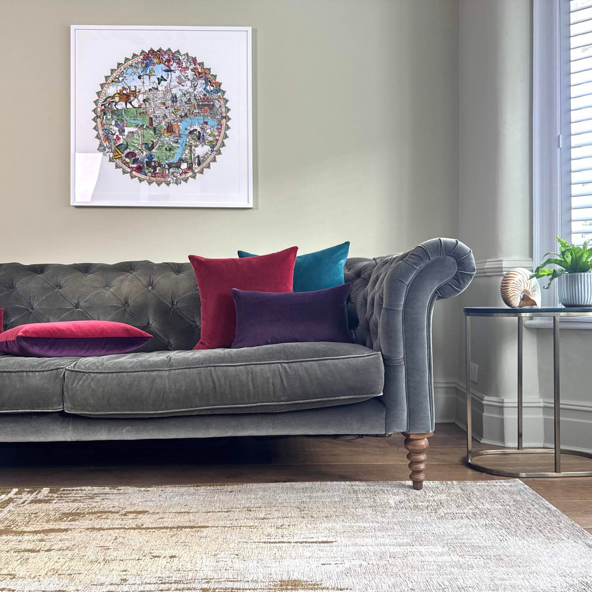 Burgundy and plum velvet cushions on grey sofa