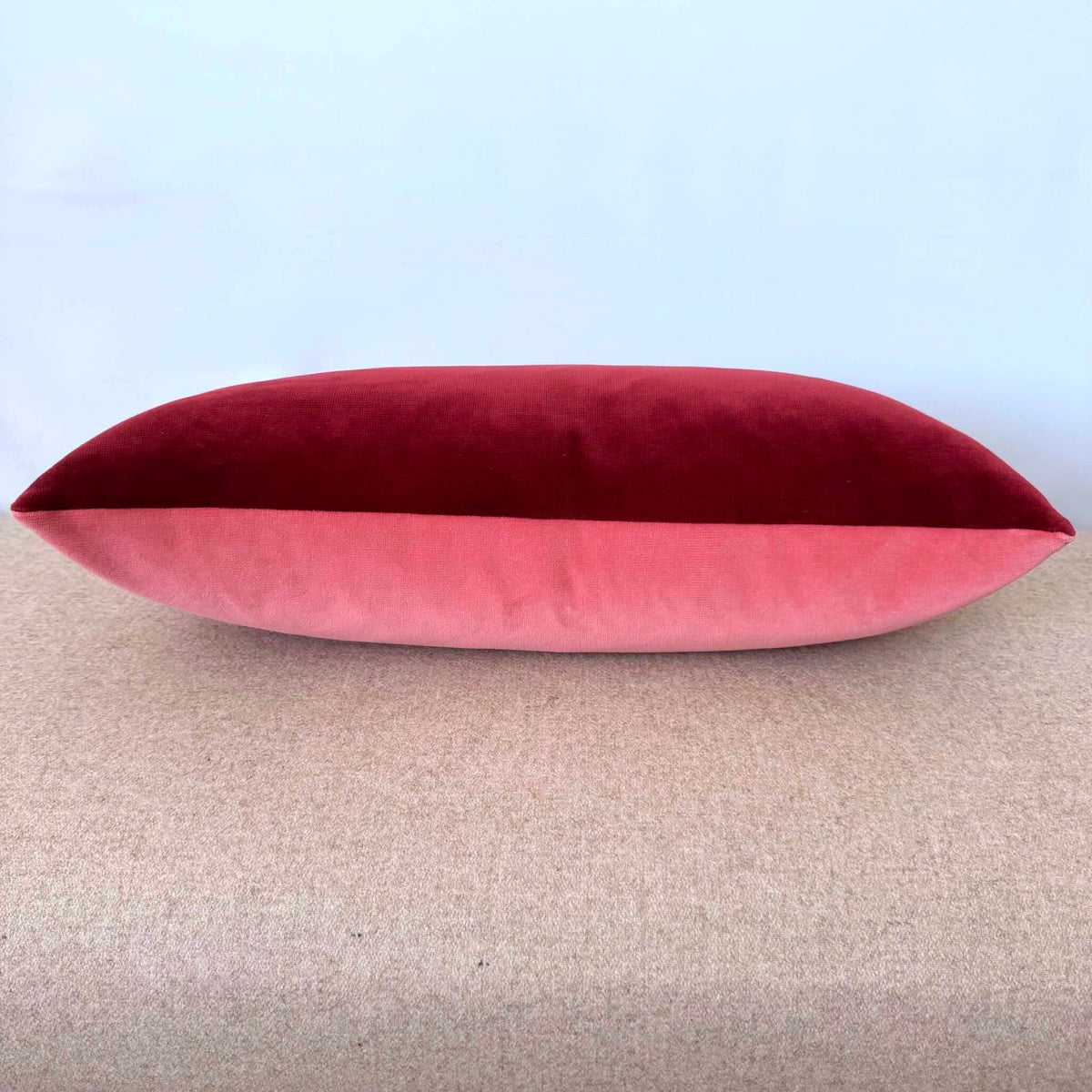 burgundy and rose pink velvet cushion on beige stool