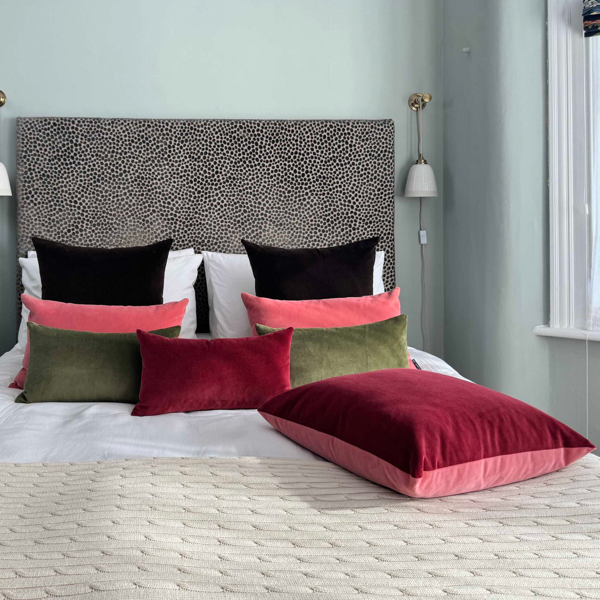 burgundy and rose pink velvet cushion with olive green and dark chocolate in blue bedroom