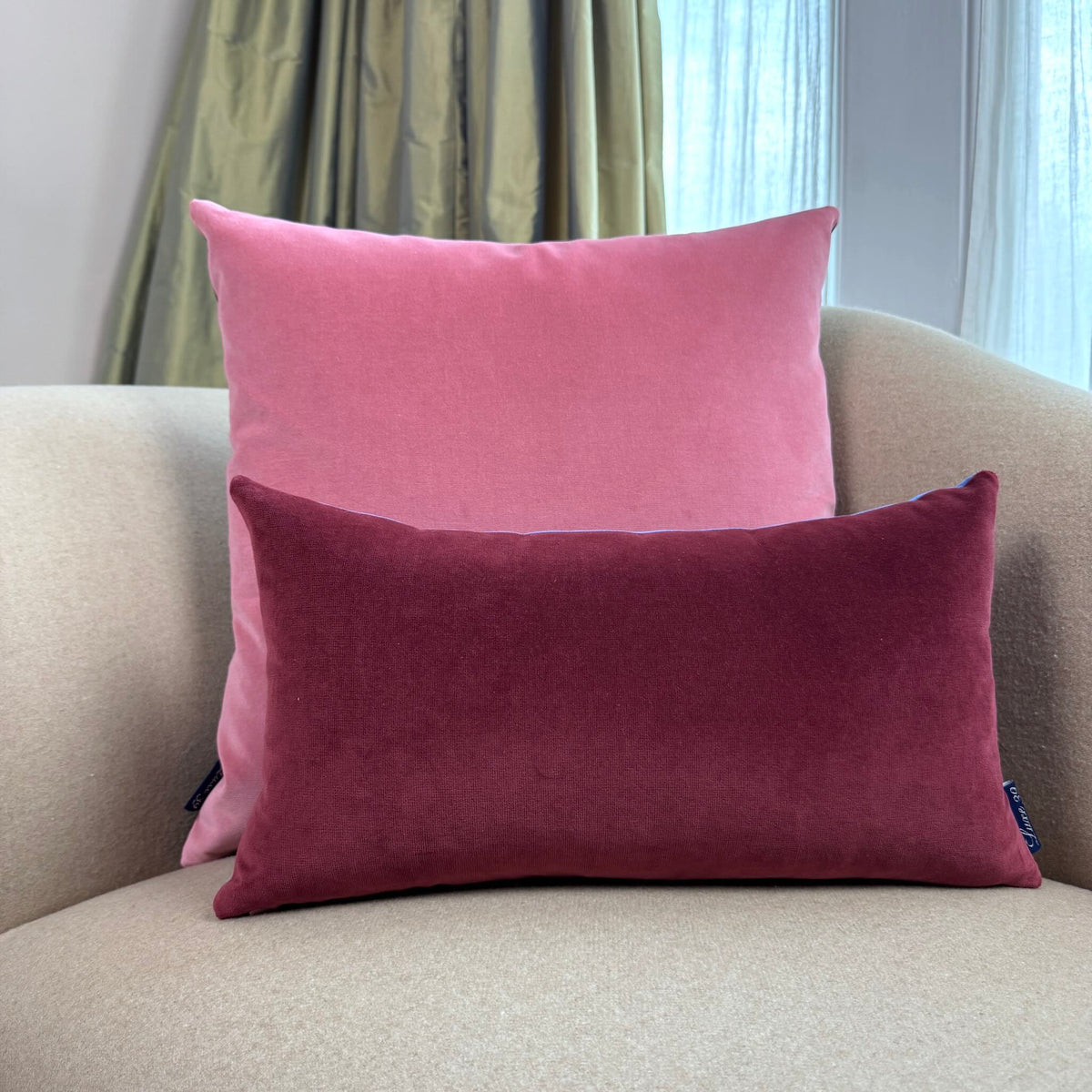 burgundy and rose pink velvet cushion cover on beige sofa
