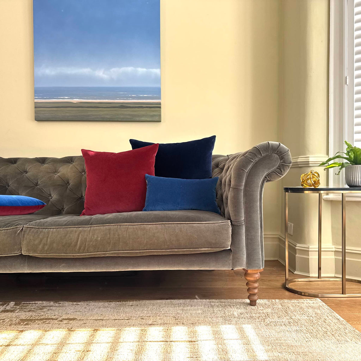 burgundy velvet cushion on grey sofa