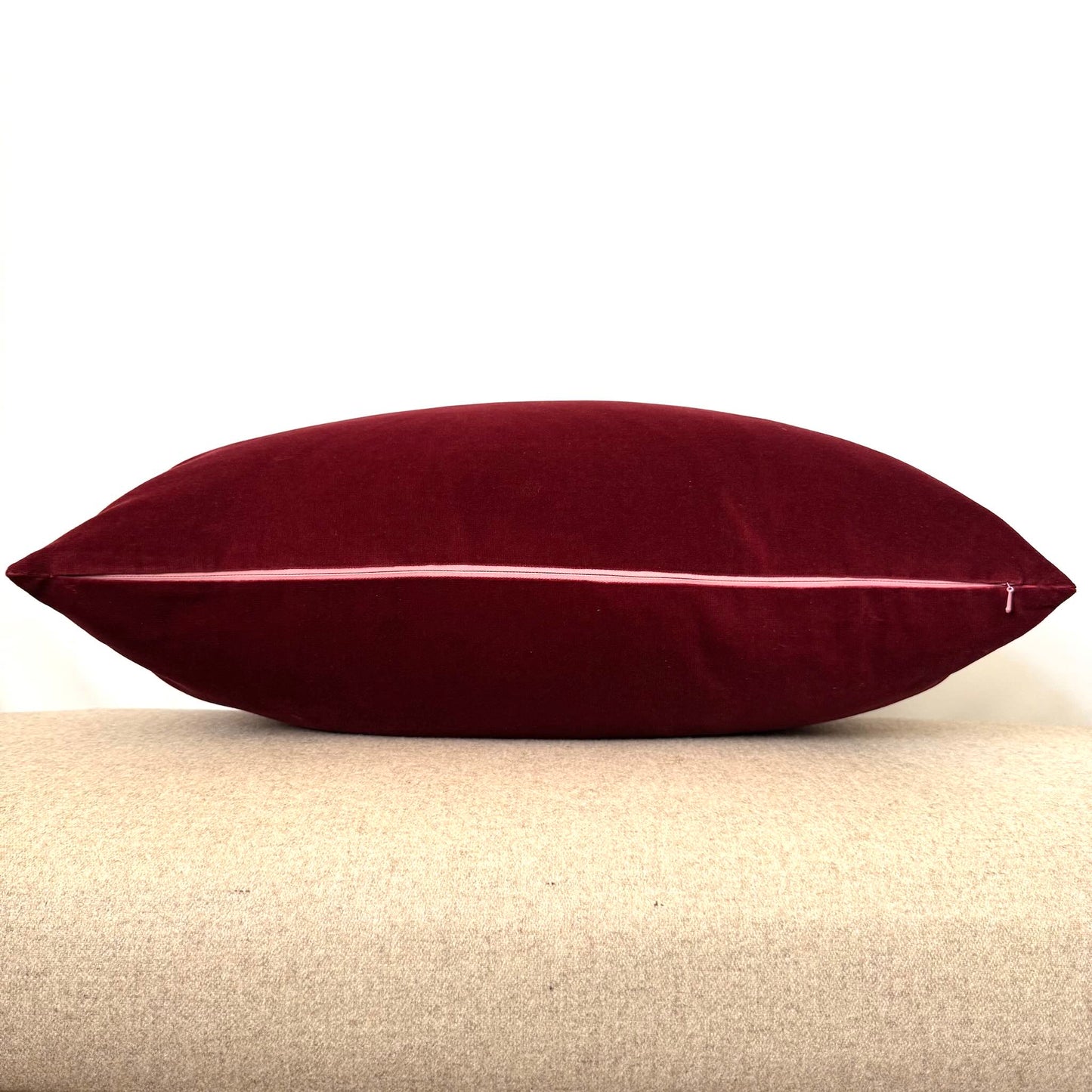 burgundy velvet cushion with pink zip