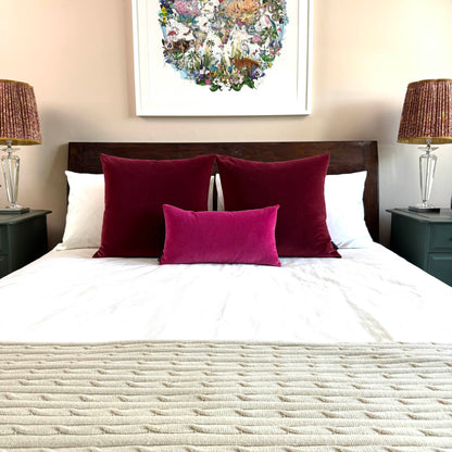 burgundy velvet cushions with fuscia velvet cushion styled on wooden bed