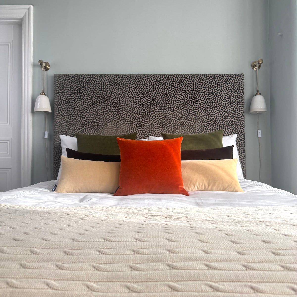 burnt orange velvet cushion with champagne, dark chocolate and olive