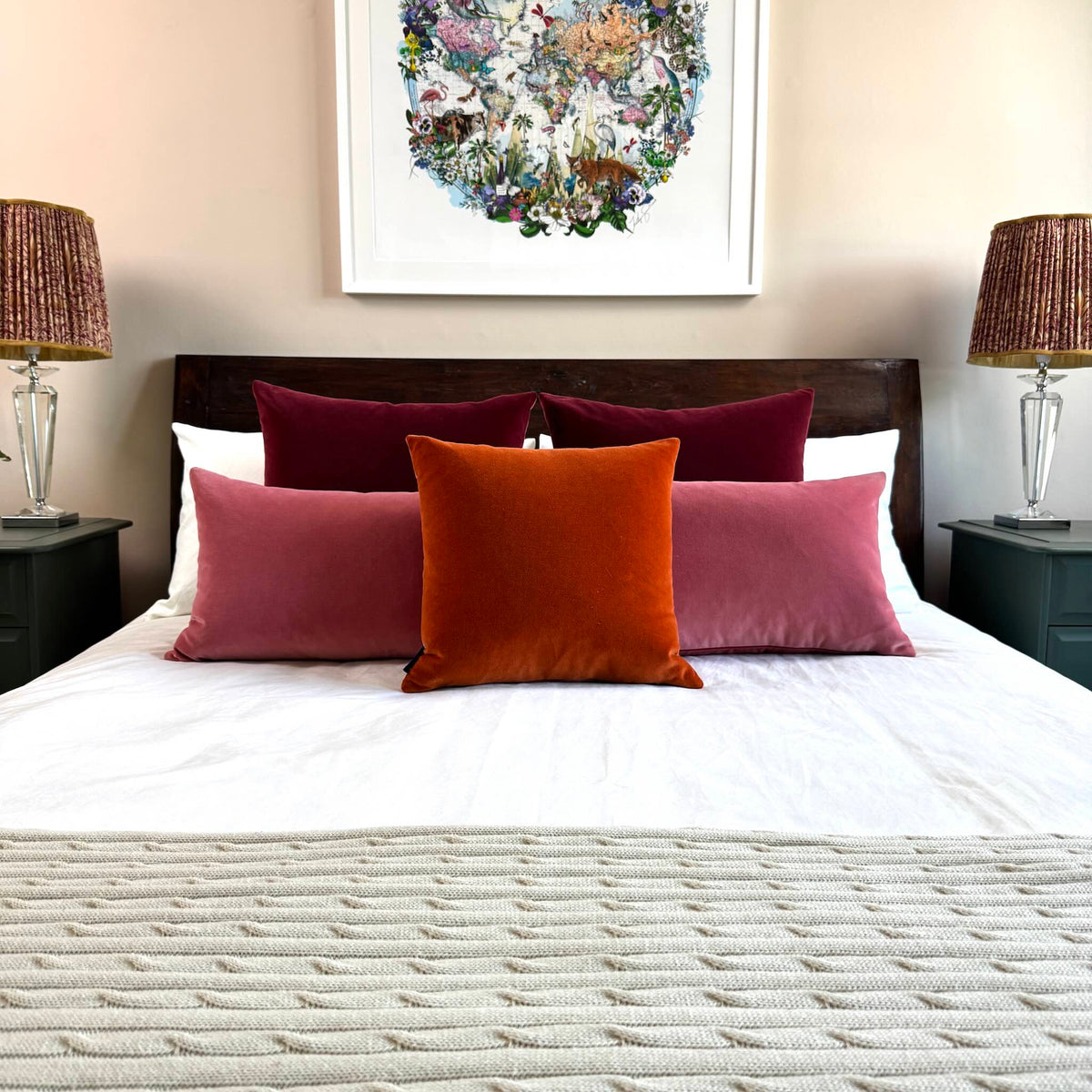 burnt orange velvet cushion cover with rose and burgundy on wooden bed
