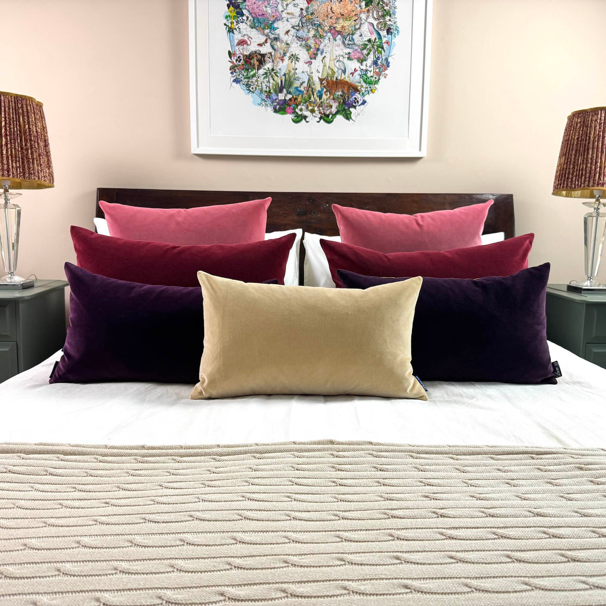 champagne cream velvet cushion on white bedding with berry cushions