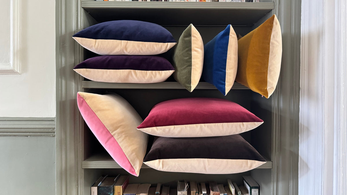 champagne velvet cushions on a bookshelf by luxe 39