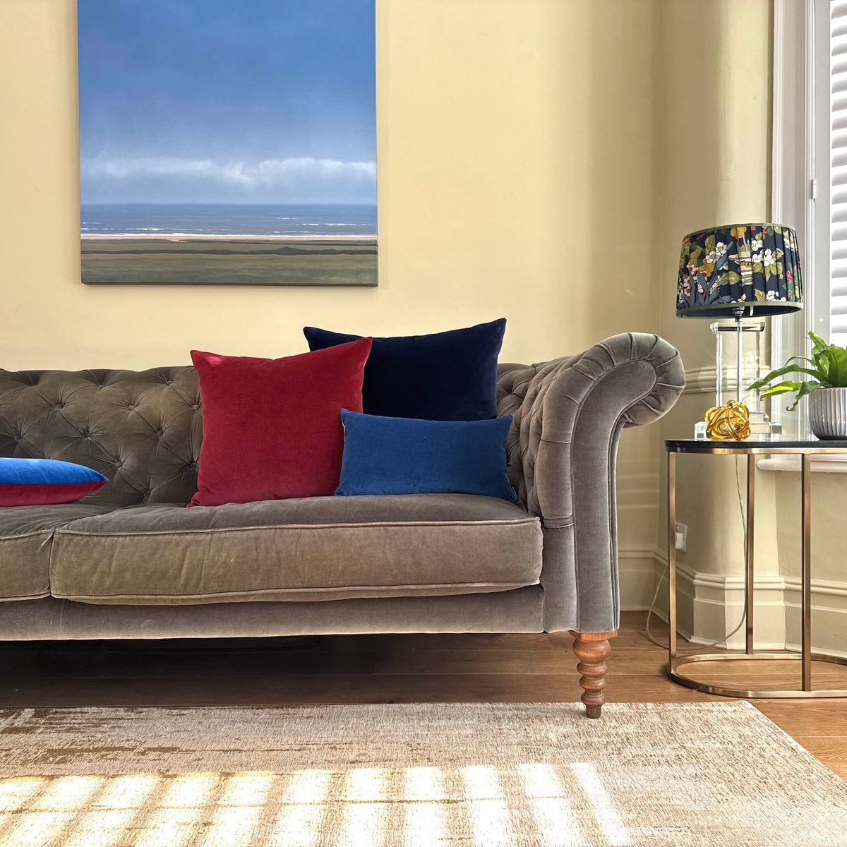 cobalt blue and navy velvet cushions on grey sofa