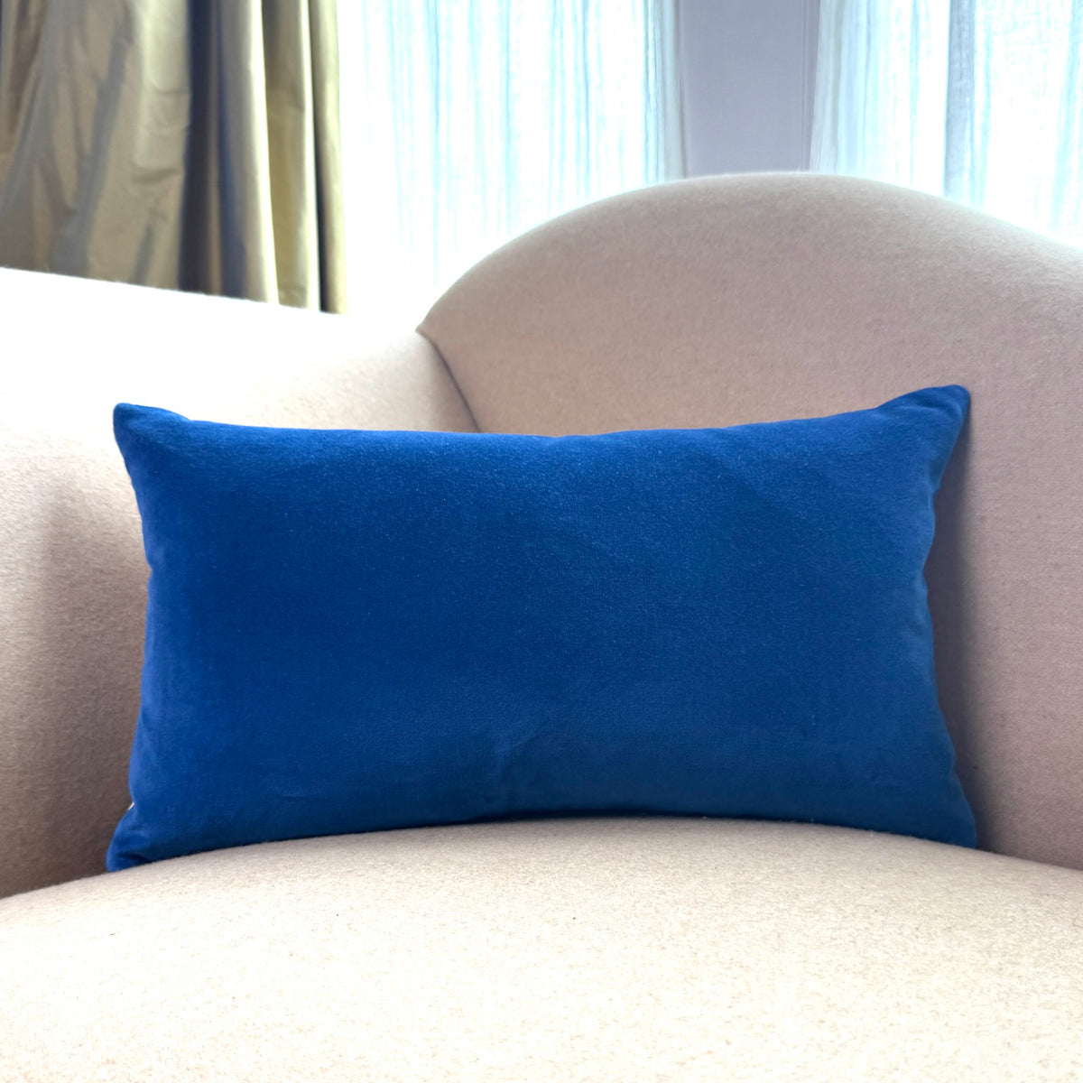 cobalt blue velvet cushion rectangle on beige sofa