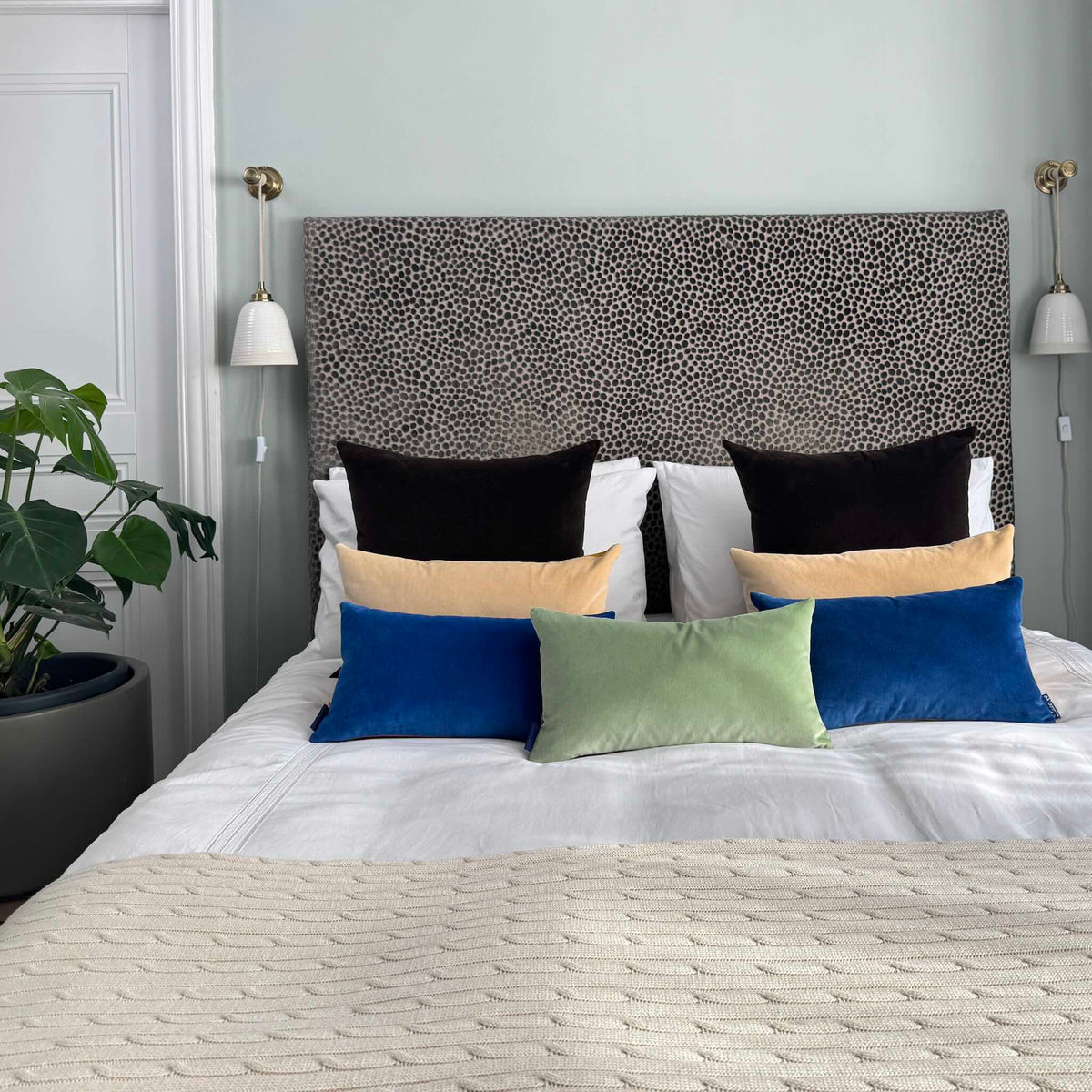 cobalt blue velvet cushion with sage green in blue room