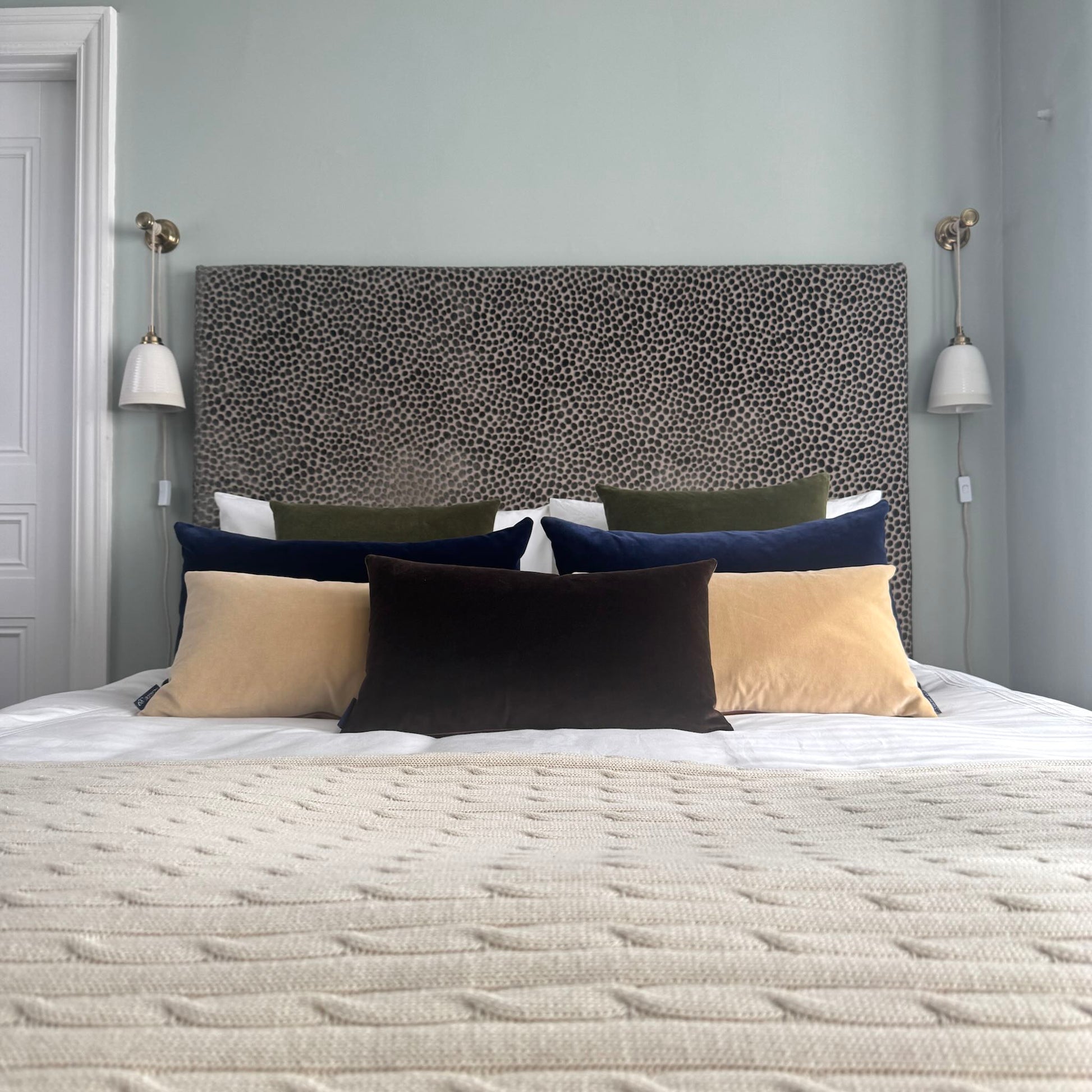 dark chocolate velvet cushions in blue room with cool colour scheme