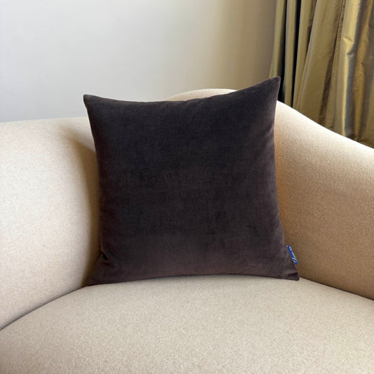 dark chocolate velvet cushion on beige sofa