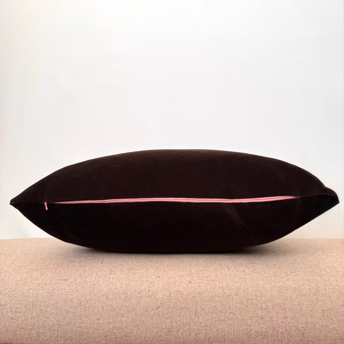 dark chocolate velvet cushion with pink zip