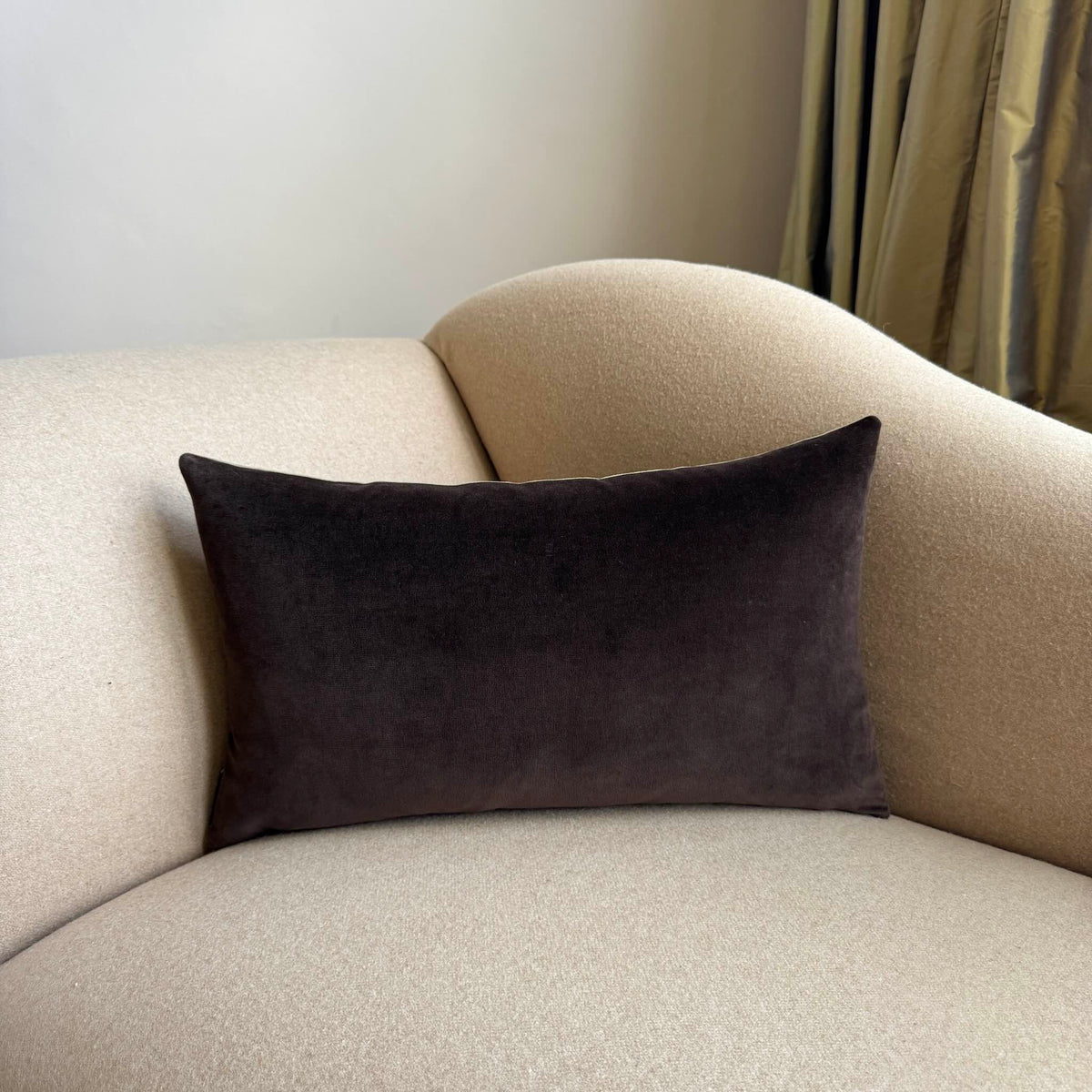 dark chocolate brown velvet rectangular cushion on beige sofa