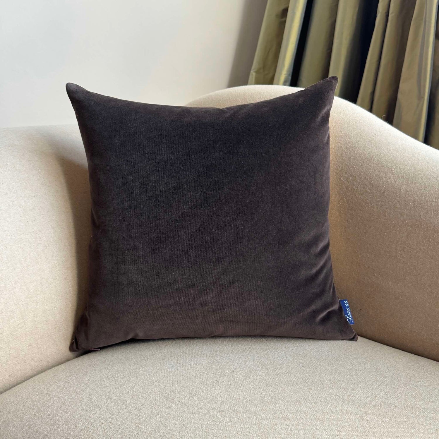 dark chocolate velvet cushion on beige sofa