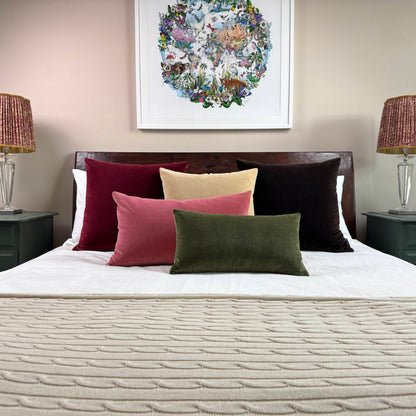 dark chocolate velvet cushions on wooden bed