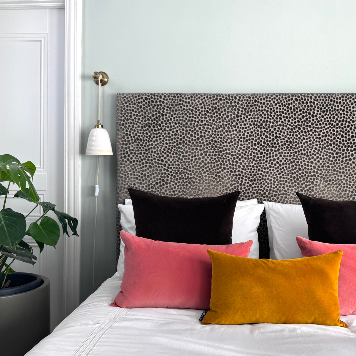 gold ochre velvet cushion with rouge and dark chocolate in blue room