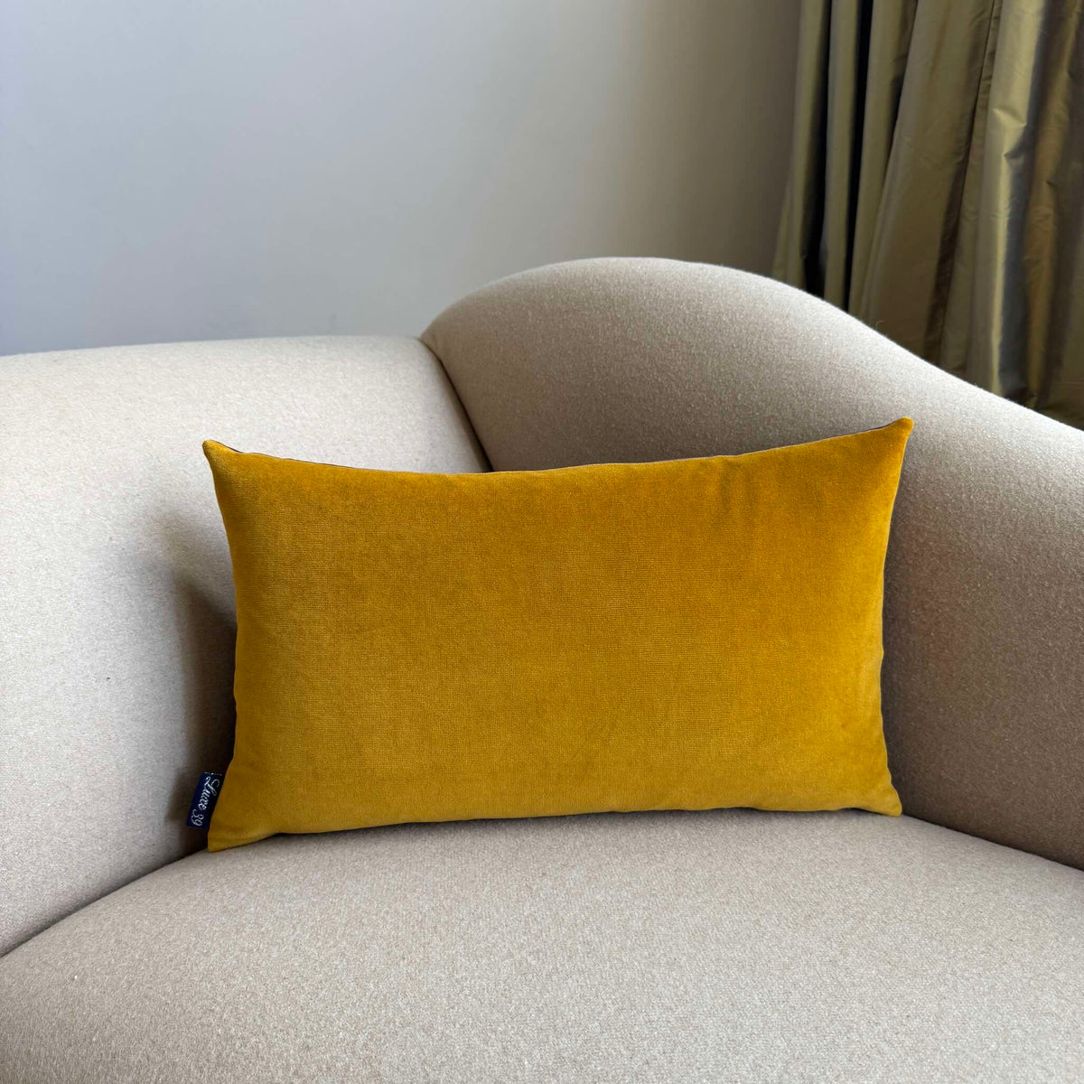 gold ochre velvet cushion rectangle on beige sofa