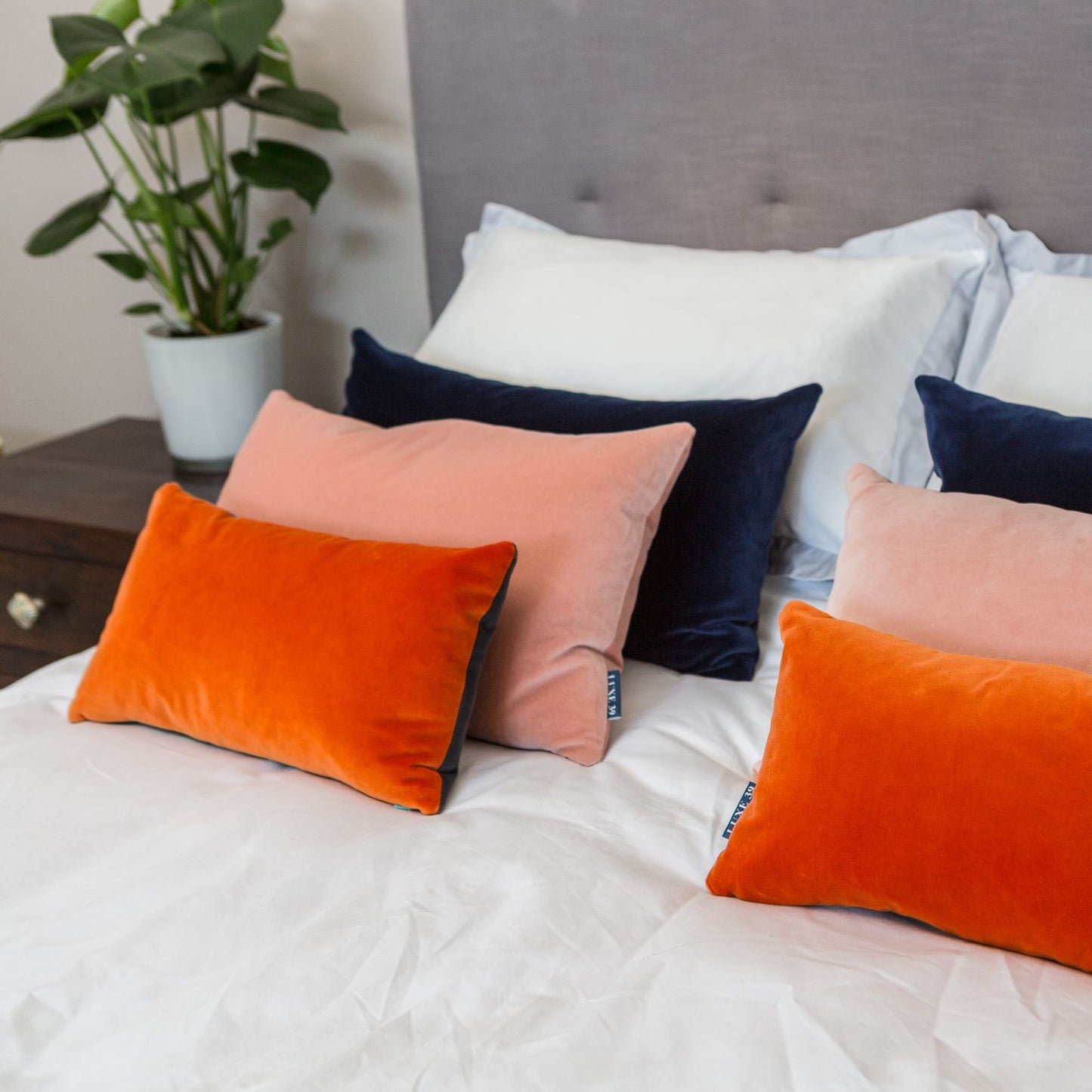 orange and navy reversible velvet cushions with blush pink