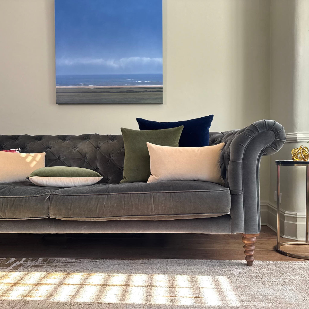 olive green and champagne velvet cushion cover on grey sofa