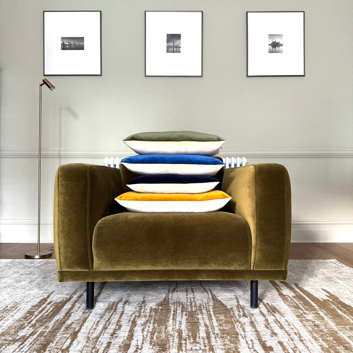 olive green and champagne velvet cushion piled on green chair