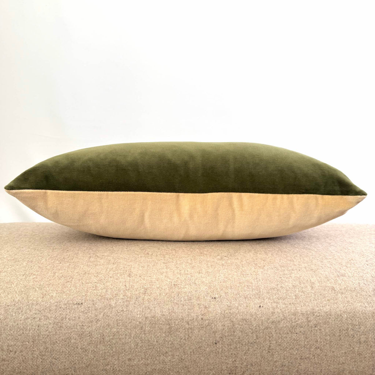 olive green and champagne double colour velvet cushion on beige stool