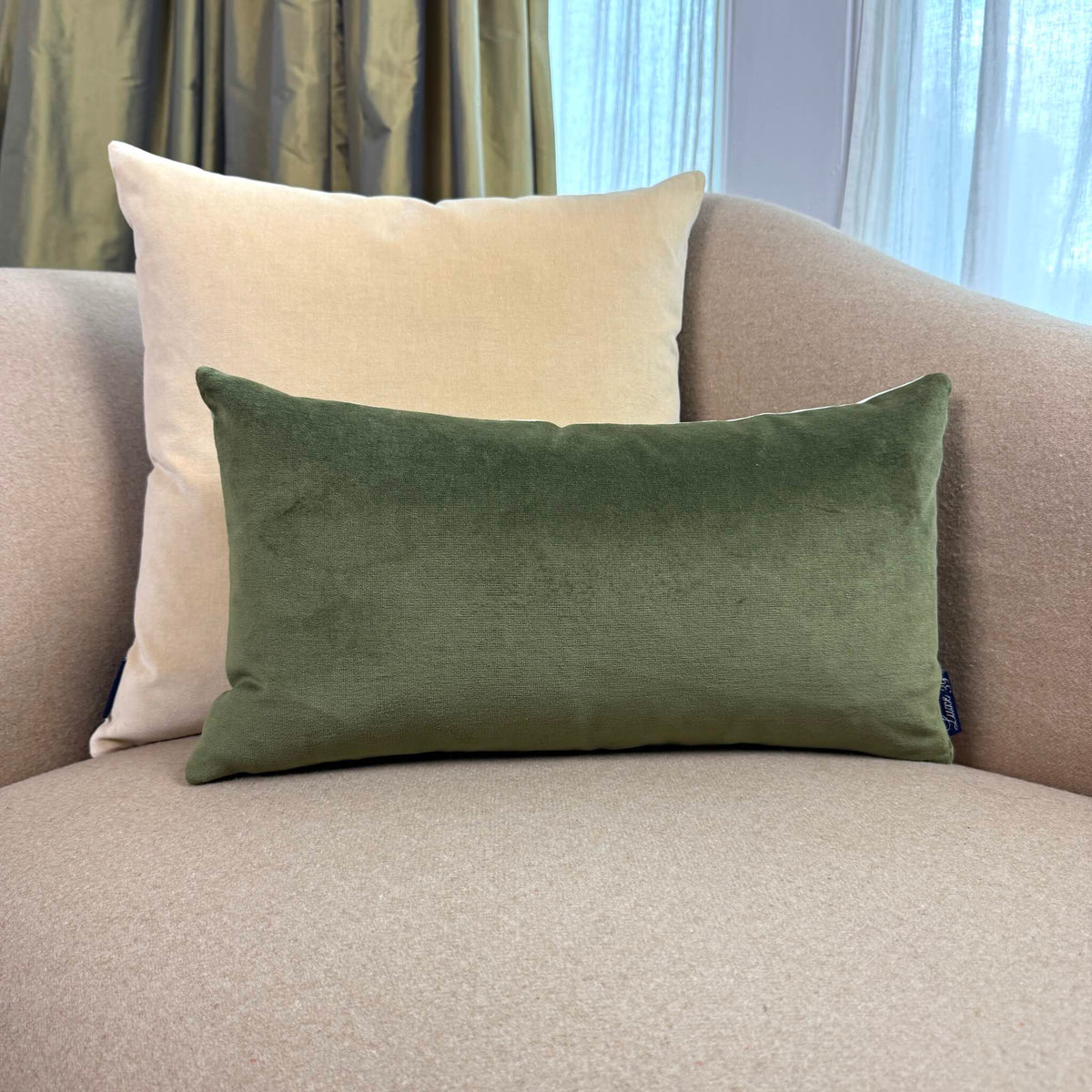 olive green and champagne reversible velvet cushion on beige sofa