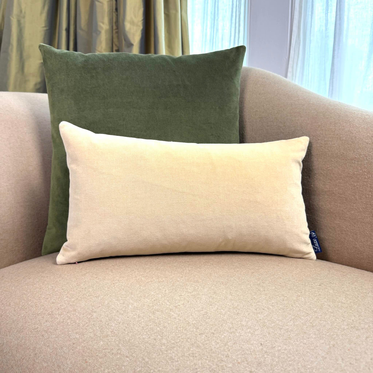 olive green and champagne velvet cushion on beige sofa