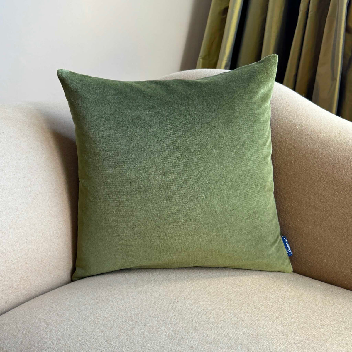 olive green velvet cushion cover square on beige sofa