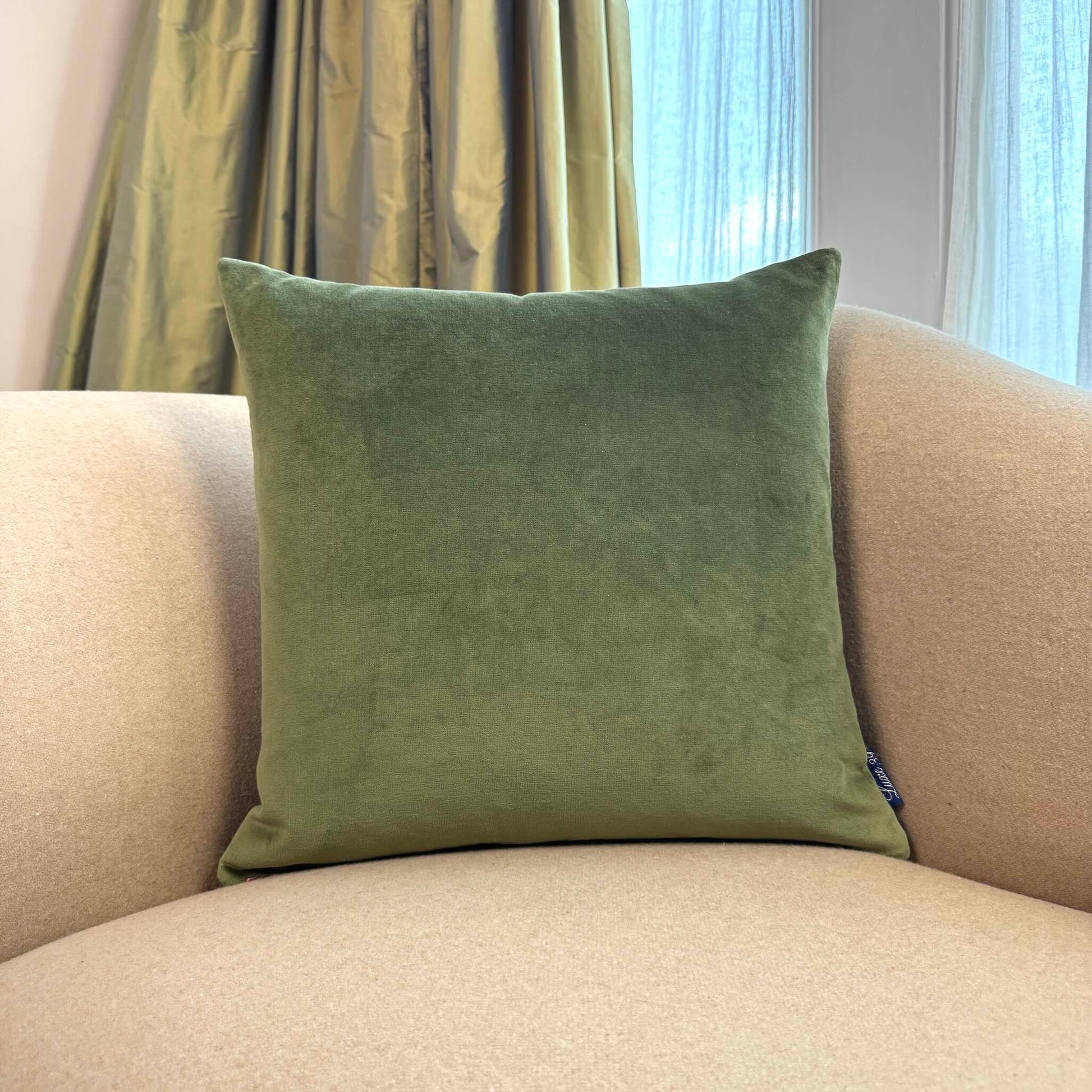 olive green velvet cushion square on beige sofa