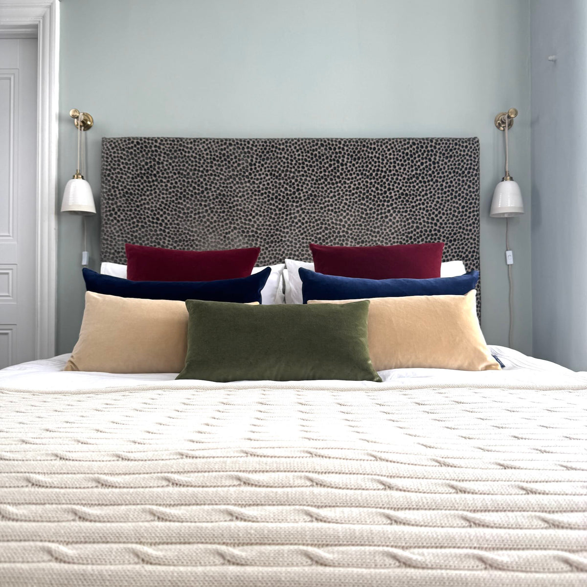 olive green velvet cushion rectangle with champagne and navy cushions in blue room