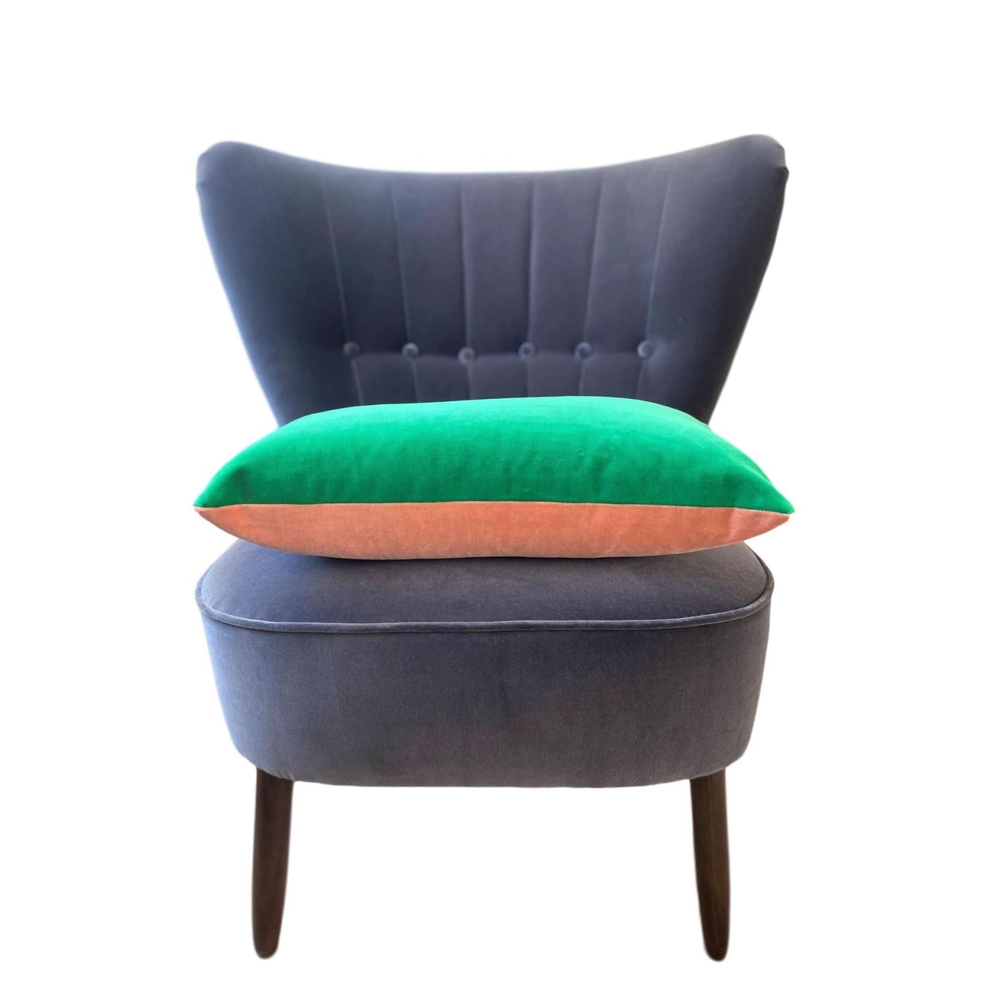 pink and green cushion covers on a grey velvet chair