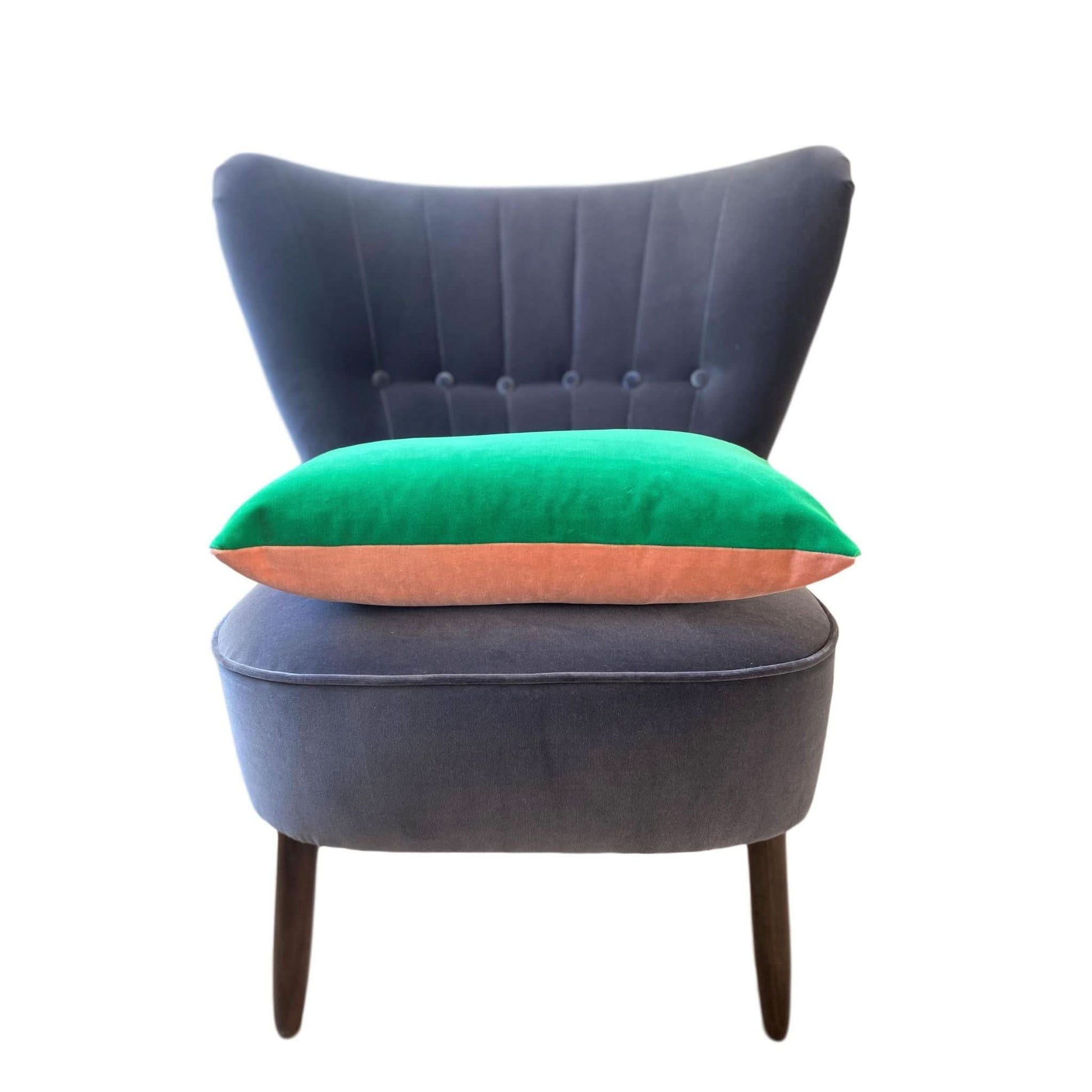 pink and green cushion covers on a grey velvet chair